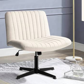 a reviewer photo of an armless chair in cream 