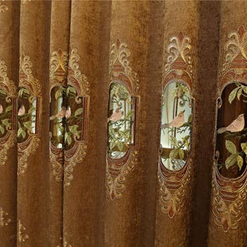 Elegant curtains with ornate vertebrate  and leafage  embroidery pattern