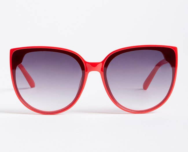 Chic oversized reddish cat-eye sunglasses with gradient lenses, perfect for a bold manner statement