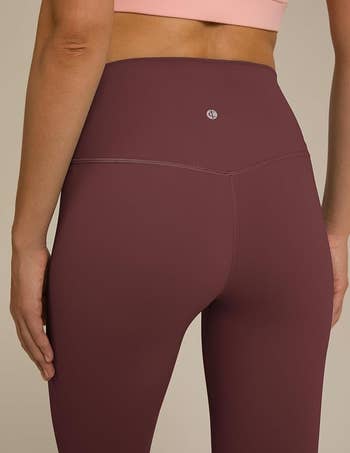 close up back view of model in the leggings in plum red