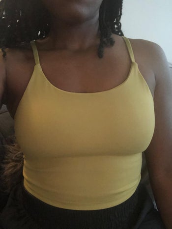reviewer wearing the yellow tank top