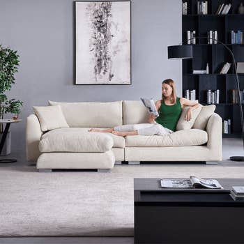 a front view of the white couch and a model laying on it