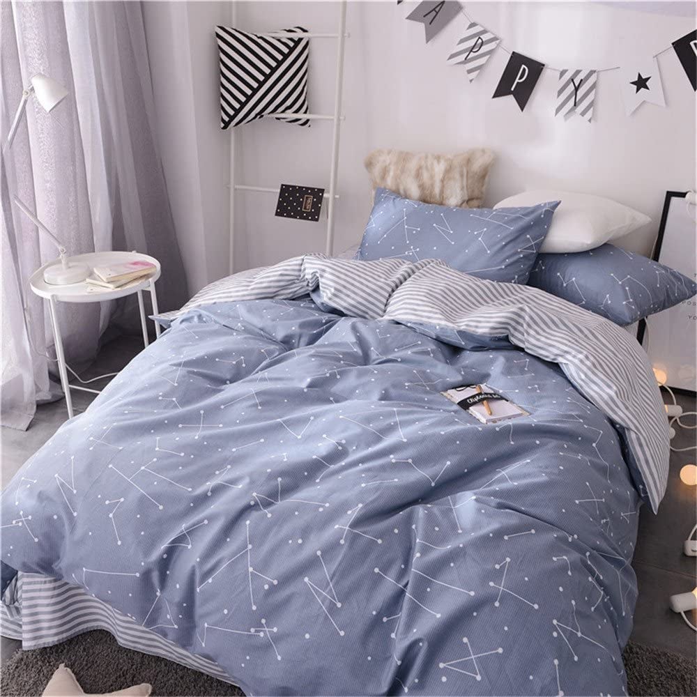 a bed with a blue constellation-printed duvet set on it