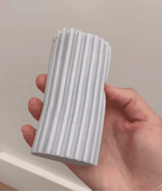 GIF of reviewer using the sponge duster to clean baseboards