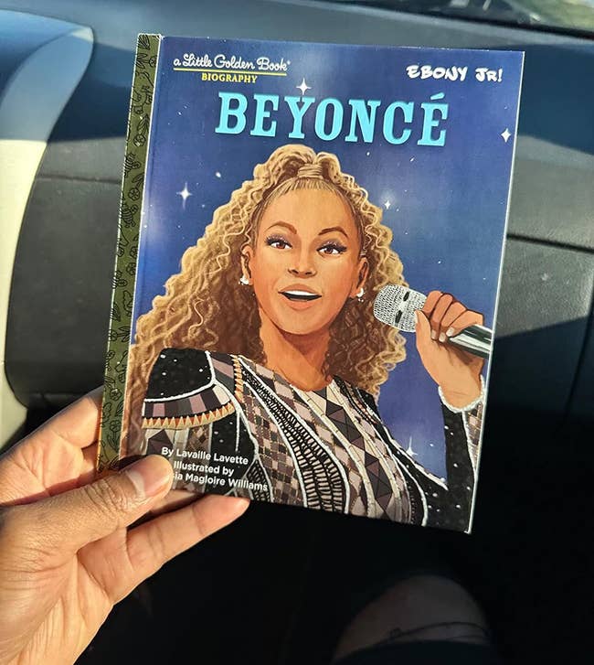 An illustrated Beyoncé biography book held by a person