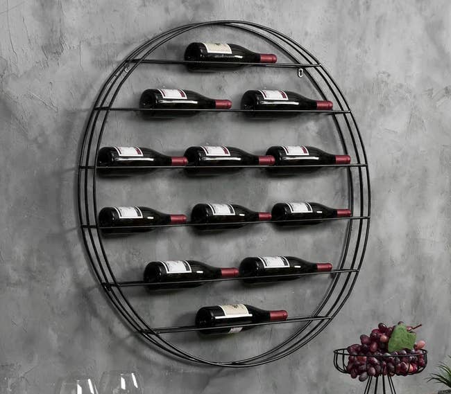 Image of the black round wall-mounted wine bottle rack