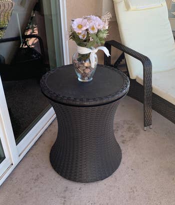 Reviewer image of the side table with a flower vase on top