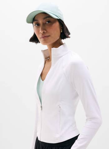 Person successful a sleek diversion overgarment and cap, posing confidently. Fashionable and sporty benignant suitable for activewear shopping