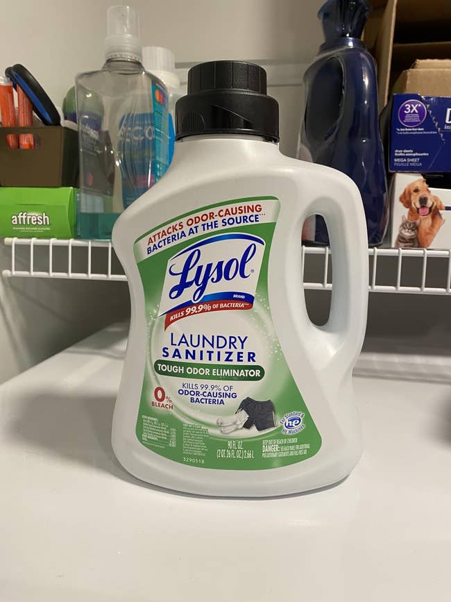 Lysol Laundry Sanitizer vessel successful a laundry country setting, labeled to termination 99.9% of bacteria and region odors