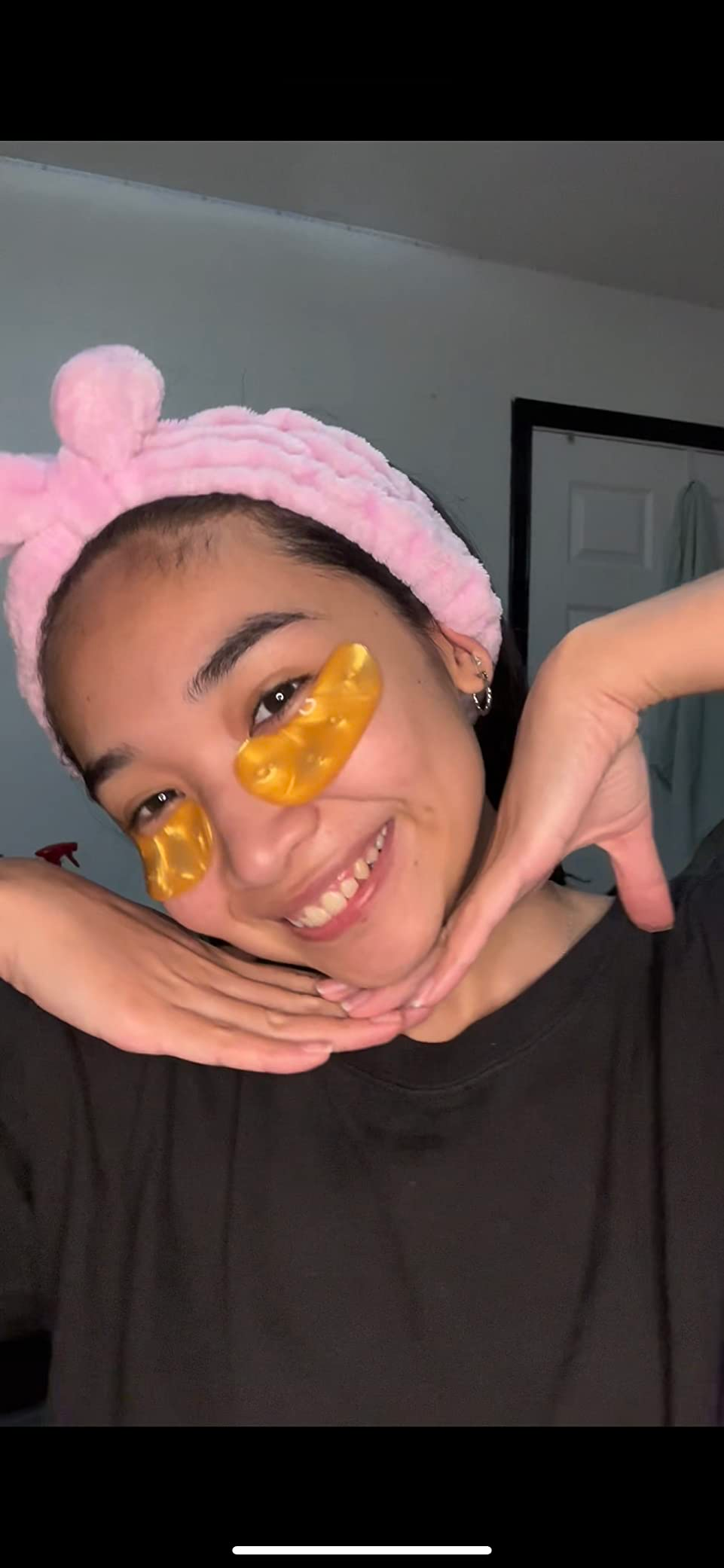 A reviewer wearing the gold under eye masks