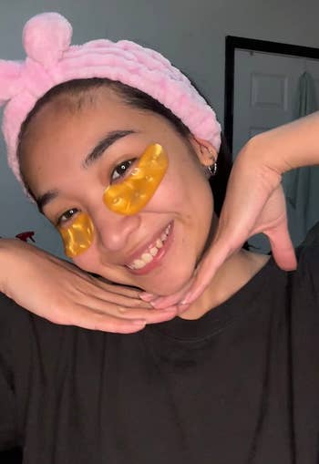 A reviewer wearing the gold under eye masks