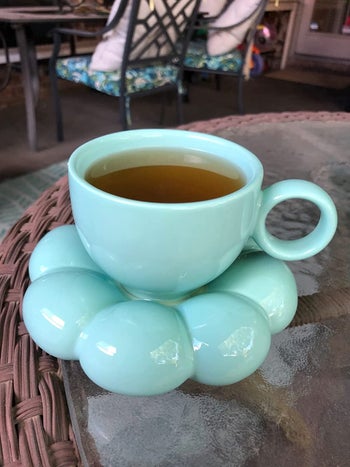 some tea in the blue coffee mug on a sunflower coaster
