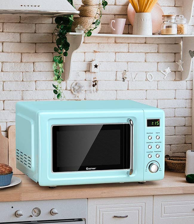 the light blue microwave on a kitchen counter