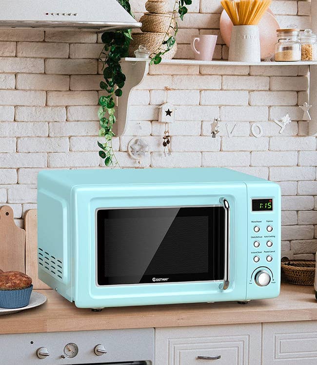 the light blue microwave on a kitchen counter