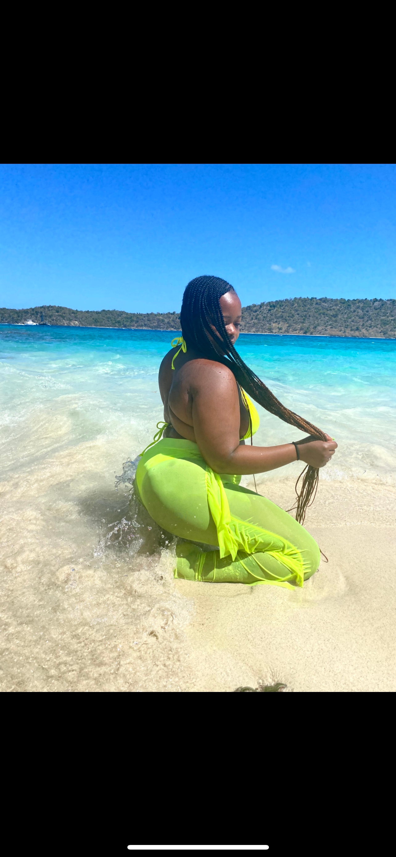 reviewer kneeling and wearing the green pants in water