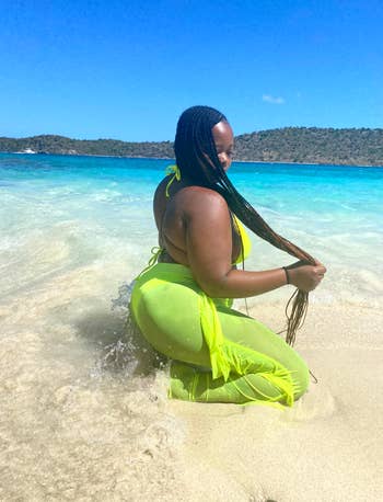 reviewer kneeling and wearing the green pants in water