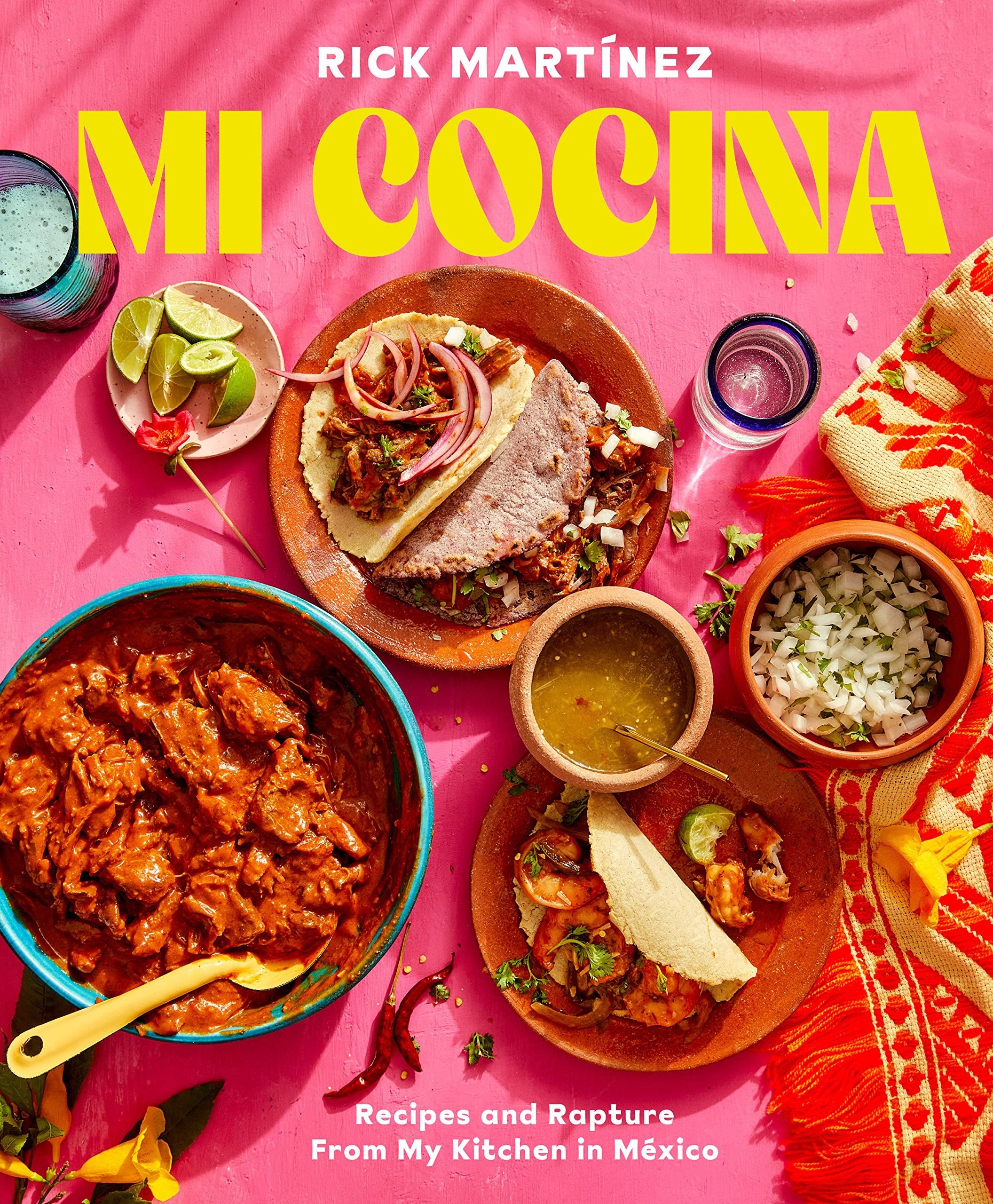 the pink Mi Cocina cookbook cover featuring plates of tacos and other Mexican dishes
