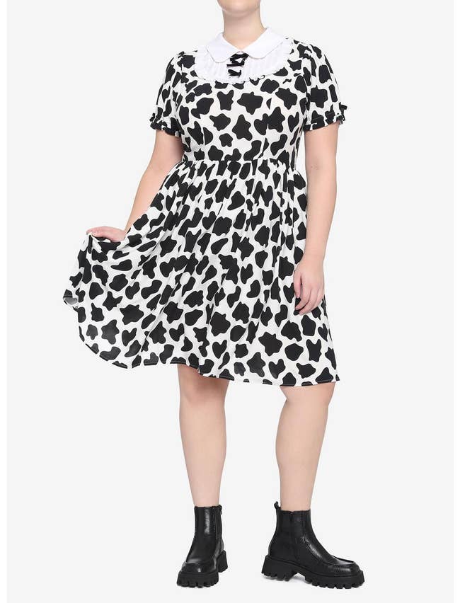 model in short sleeve fit and flare knee length cow print dress with white collar and bib