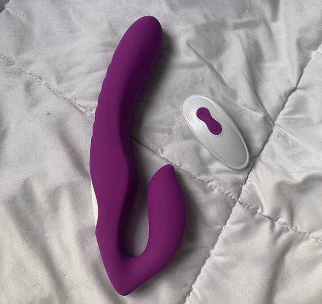 Purple dual-ended dildo with white wireless remote