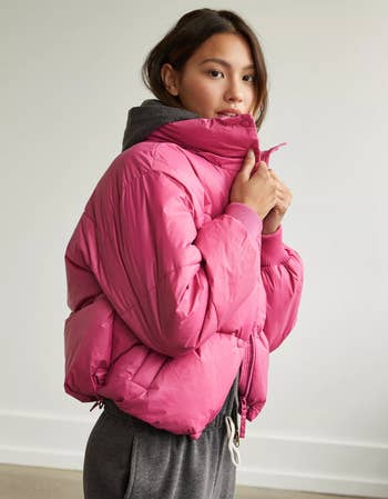 a model in a pink puffer coat