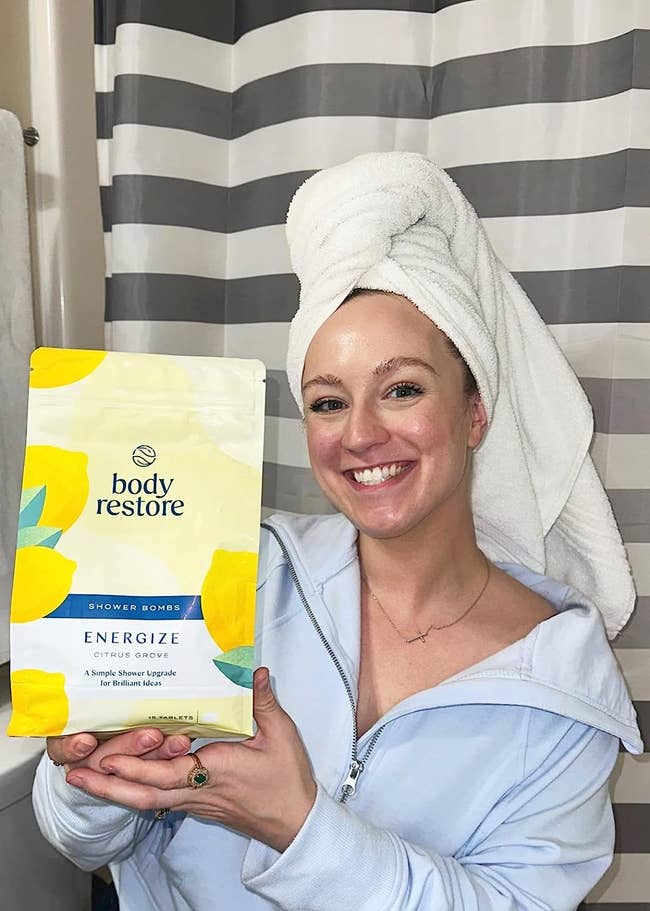 Reviewer holding bag of bath fizzes 