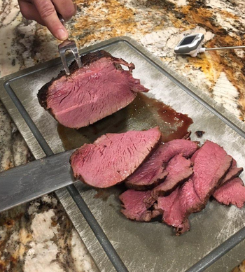 reviewer cutting into steak cooked using the sous vide