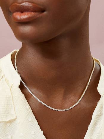 a model wearing a tennis necklace
