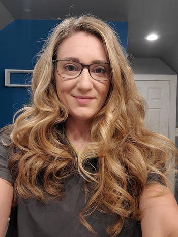 reviewer's voluminous curly hair from using the rod