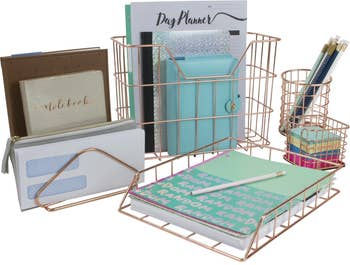 Organized desk set with planner, notebooks, pencil holder, and file trays, ideal for efficient workspace organization