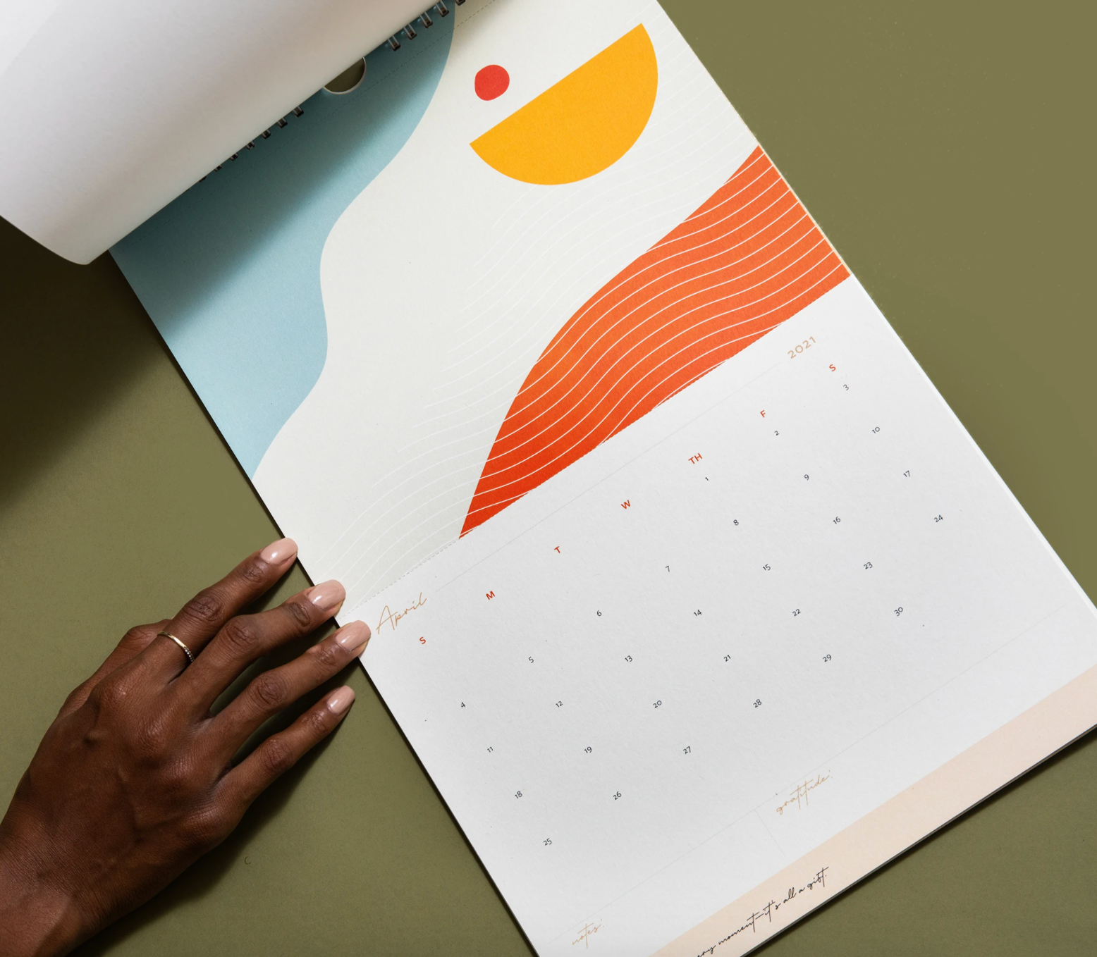 A hand is touching a calendar