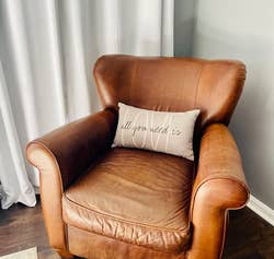 reviewer photo of the same leather chair after using the leather cleaner - looking significantly better