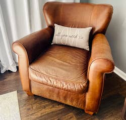 reviewer photo of the same leather chair after using the leather cleaner - looking significantly better