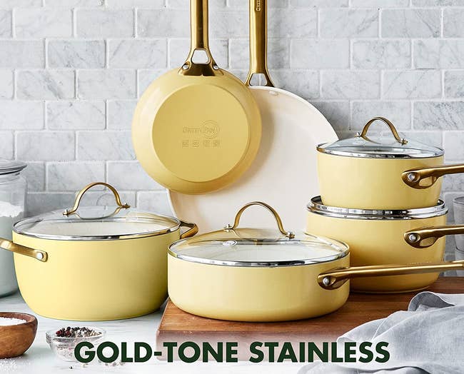 a set of yellow pots and pans