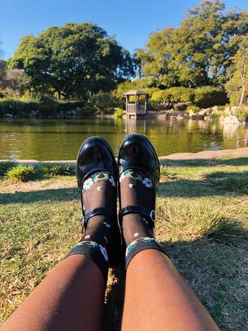 reviewer wearing mary jane shoes with floral sheer print socks
