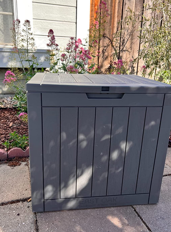 a reviewer photo of a square storage box outside 