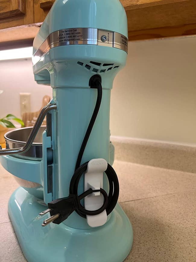 reviewers blue stand mixer with cord neatly organized on the back