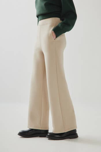 another model wearing the sand-colored pants