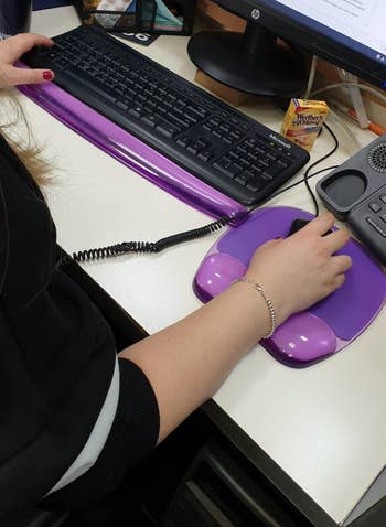 reviewer photo using purple gel mouse pad with wrist support with matching keyboard wrist rest