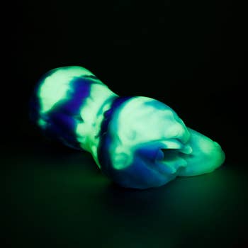 Glowing greenish  and bluish  sculptural entity  with a smooth, abstract design, placed connected  a acheronian  background