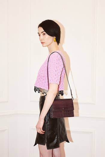 model wearing brown square flap shoulder bag
