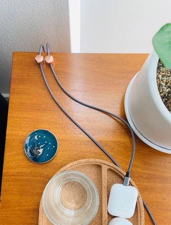 the rose gold cable organizers used on a desk