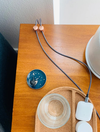 the rose gold cable organizers used on a desk
