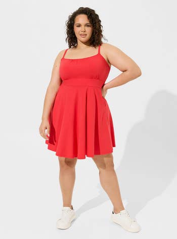 Model in a sleeveless red skater dress