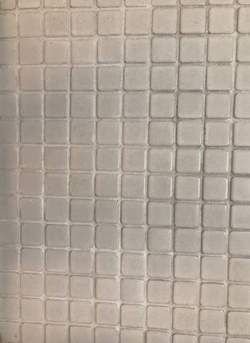 after photo showing same bathroom tiles now looking clean after using the grout pen