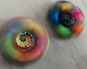 Reviewer image of two fidget spinners spinning