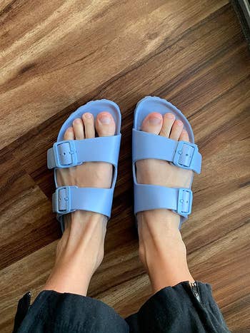 reviewer photo of them wearing blue sandals 