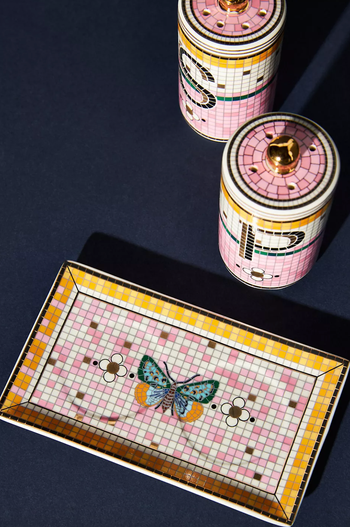 tile salt and pepper shakers next to a tiled tray with a butterfly on it