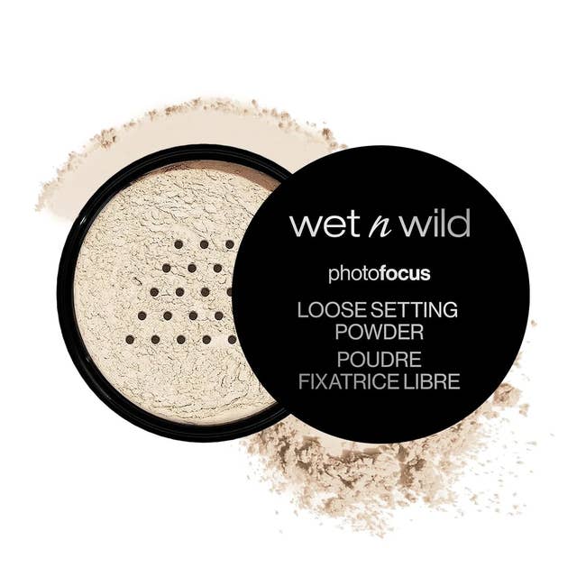 Loose setting powder from Wet n Wild's Photo Focus line, shown with some powder spilled around the container