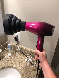 Reviewer's travel diffuser attached to a blowdryer, side view