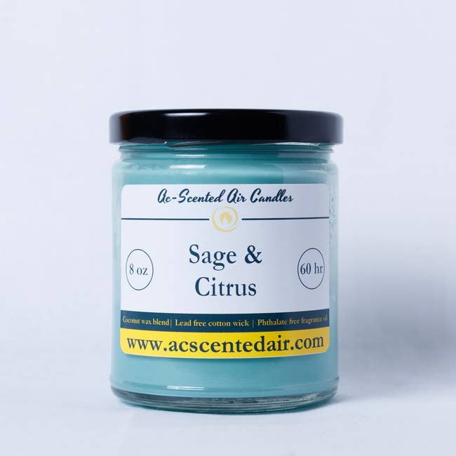 Sage and Citrus scented candle in a jar with label detailing product features like 8 oz size and 60 hr burn time, and website address